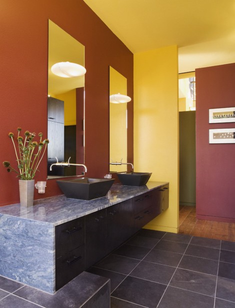 brightly coloured bathroom with double basin and marble granite tops