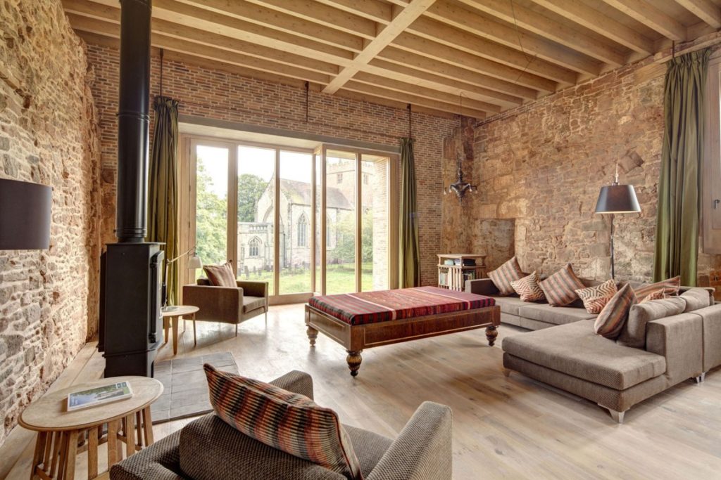 castle living room with woodburning stove and large ottoman