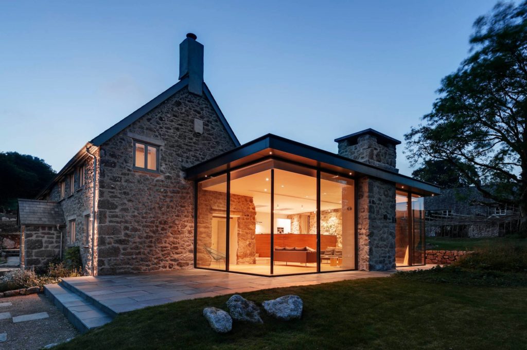 classic stone farmhouse with modern glass extension