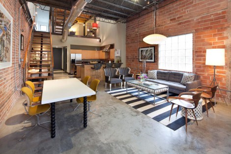 concrete flooring with george nelson light and exposed brick wall