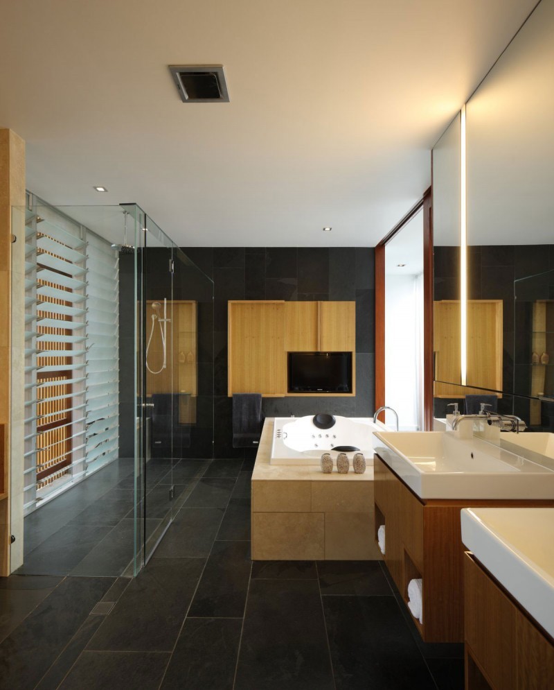 grey slate bathroom with modern light bath and walk in shower