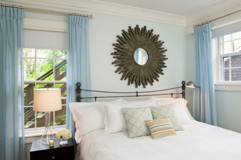 light blue bedroom with funky mirror