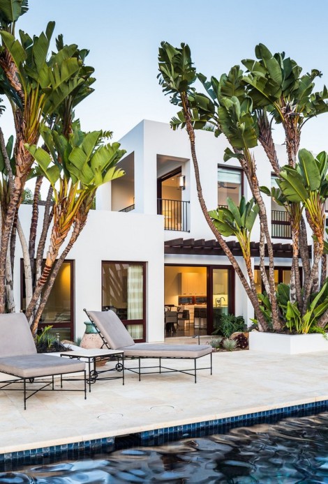 Mediterranean and contemporary architecture mixing with palm trees and poolside