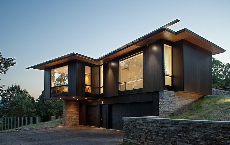 modern black house on a mountain lake