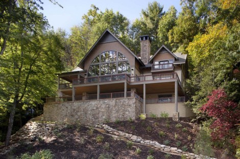 house nestled into the slope of trees